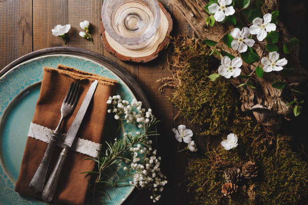 plate and cutlery with moss, flower and old piece of wood